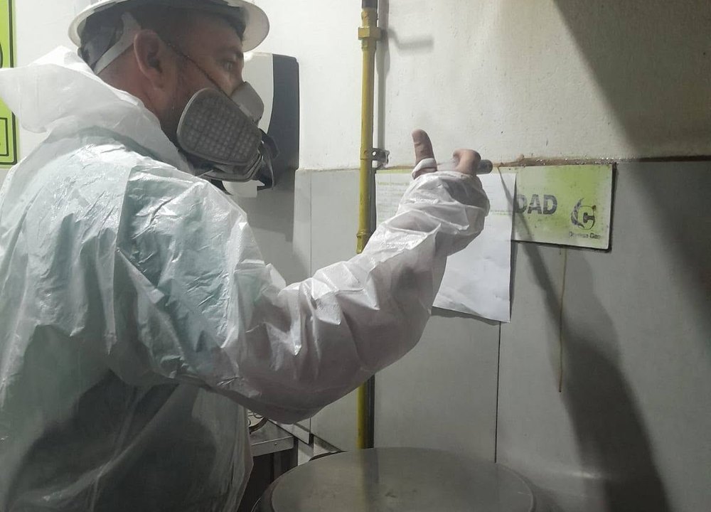 Técnico de Fumigari aplicando tratamiento en una cocina institucional